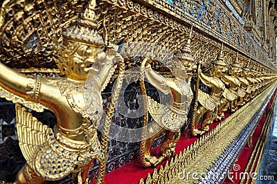 Golden garuda figures on exterior building of Wat Phra Kaew, Bangkok Stock Photo