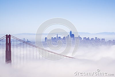 Golden Gate and the San Francisco bay covered by fog, the financial district skyline in the background, as seen from the Marin Stock Photo