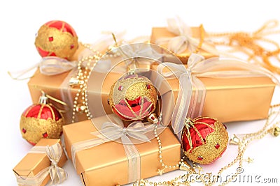 Golden gift boxes with golden ribbon and chrismas balls on white Stock Photo