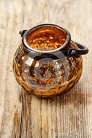 Golden glass lantern on wooden table Stock Photo