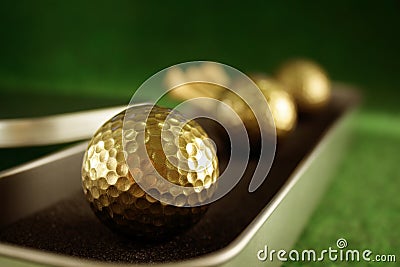 Golden golfballs in gift set Stock Photo