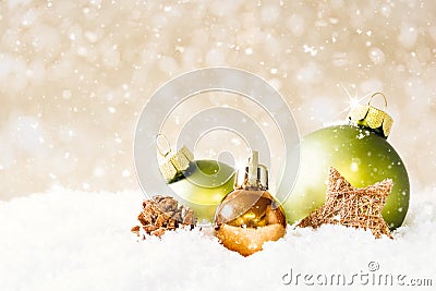 Golden and Green Christmas Balls with falling Snow Stock Photo