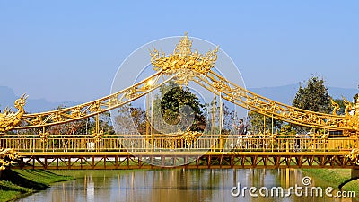 Golden Hall of Ganesha with small bridge, ornate arch with tourist in face mask Editorial Stock Photo