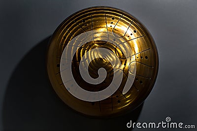 Golden hang drum on a black background, near view, centered object Stock Photo