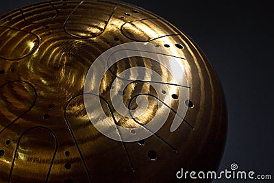 Golden hang drum on a black background, near view, closeup Stock Photo