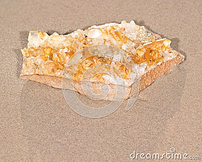 Golden Healer Cluster Quartz Specimen from Arkansas on wet sand on the beach Stock Photo