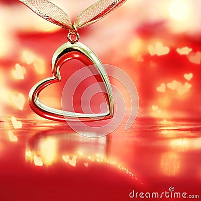 Golden heart on blazing red background Stock Photo