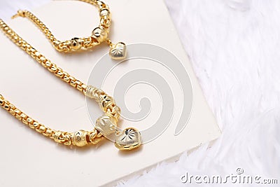 Golden heart pendant , Neck lace, Golden bracelet Stock Photo