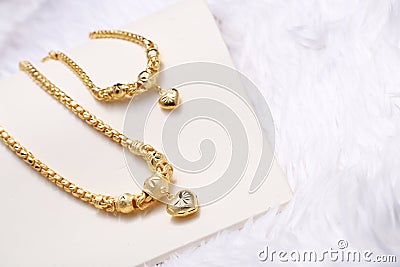 Golden heart pendant , Neck lace, Golden bracelet Stock Photo