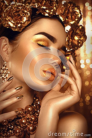 Golden holiday makeup. Golden wreath and necklace Stock Photo