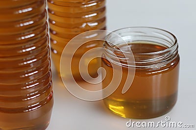 Golden homemade honey, meticulously crafted and beautifully packed in PET and glass bottles Stock Photo