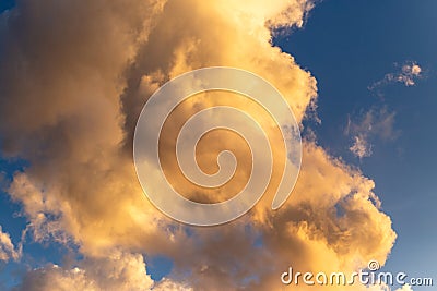 Golden hour clouds with a deep blue background Stock Photo