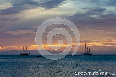 The Golden hour with sail boats on sea anchored Stock Photo