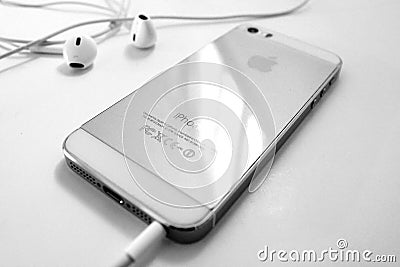 Golden iPhone 5s back and earphone wired - Black and white Editorial Stock Photo