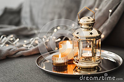 Golden lantern and burning candles on a metal tray. Traditional decor for muslim holidays Stock Photo