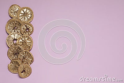 Golden lemon slices on pink background, flat lay. Space for text Stock Photo