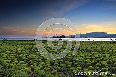 Golden light above Mount Rinjani as seen from Kenawa Island, Sumbawa, Indonesia Stock Photo