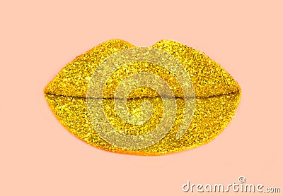 Golden lips of glitter on pastel pink background Stock Photo