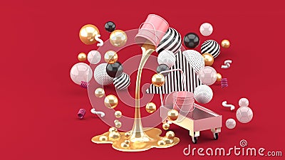 Golden liquid paints spouting from pink can among the colorful balls on the red background. Stock Photo