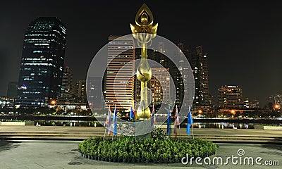 Golden lotus statue against modern buildings Editorial Stock Photo