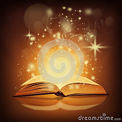 Golden magic book and sparkles Stock Photo