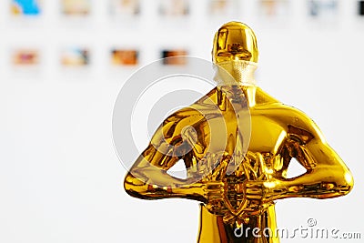 Hollywood Golden Oscar Academy award statue in medical mask. Success and victory concept. Oscar ceremony in coronavirus time Editorial Stock Photo