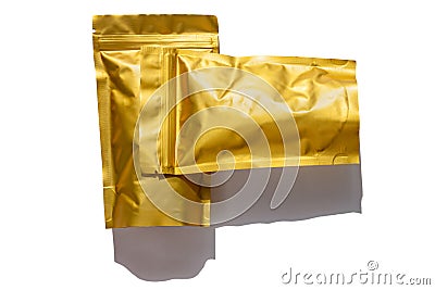 Golden metalized pouch bag with coffee beans top view with shadow isolated on white background. Food packaging flat lay Stock Photo