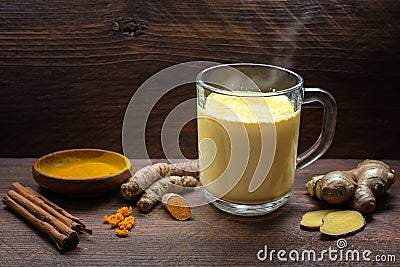 Golden milk with turmeric, ginger, cinnamon and more spices, healthy hot drink from Indian medicine Ayurveda to strengthen the Stock Photo