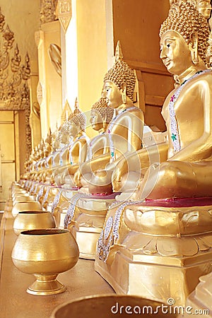 Golden monk's alms bowl and golden buddha statue Stock Photo