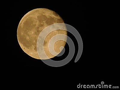 The golden moon in the light of the black heavens Stock Photo