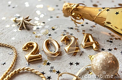 Golden 2024 new year numbers with confetti and champagne bottle Stock Photo