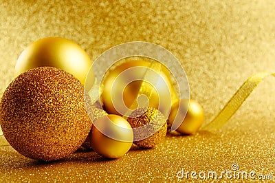 Golden New Year tree toys with glitter background. Xmas decorations. Winter holidays backdrop with copyspace. Christmas Stock Photo