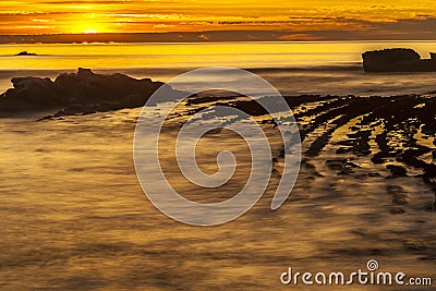 Golden Orange Sunset And Rocks Stock Photo