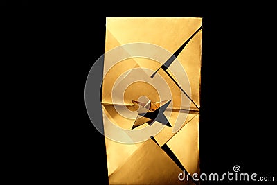 Golden origami boat with envelope on black background Stock Photo