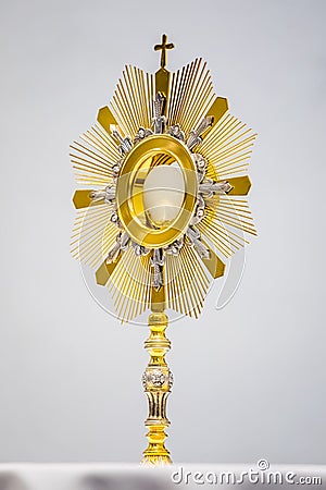 Golden Ostensory or Monstrance for worship at a Catholic church ceremony in detailed view. Stock Photo