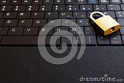 Golden padlock on black keyboard Stock Photo
