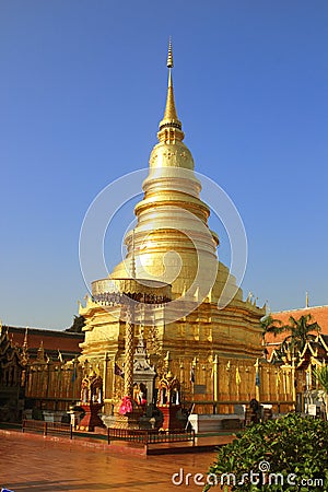 Golden pagoda at Wat Phra That Haripunchai Woramahawihan in Lamp Stock Photo