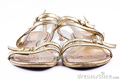 Golden painted, elegant, party shoes on a white background - front Stock Photo