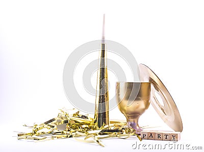 Golden painted party whistle, glass, disk with the sign - party on a white background - still life Stock Photo