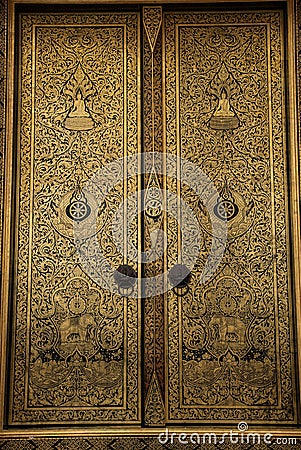 Golden painting on the ubosot door Stock Photo