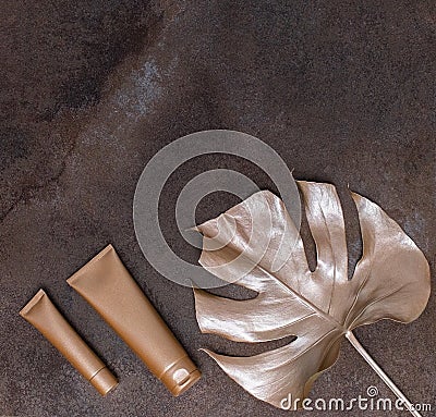 Golden palm leaf and golden bottles on the marble background. High quality photo. Stock Photo