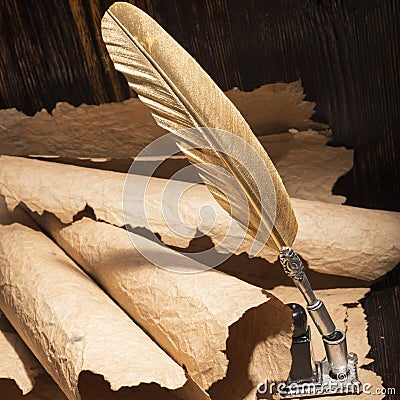 Golden pen and ancient manuscripts Stock Photo