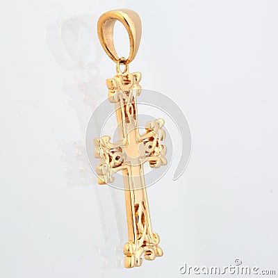 Golden pendant cross with red light stone panorama Stock Photo