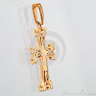 Golden pendant cross with red light stone panorama Stock Photo