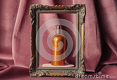 Golden perfume bottle in a frame Stock Photo