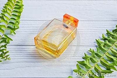 .A golden perfume bottle on a white table Stock Photo