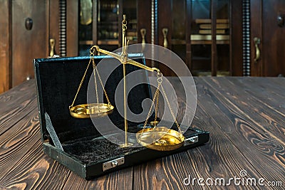 Golden pharmaceutical scales on wooden background in ancient interior. Antique and precision concept Stock Photo