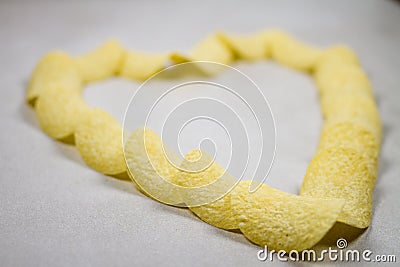 Golden Potato Chips Heart Formation Composition Isolated Over Light Gray Grey White Background Stock Photo