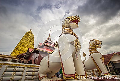 Golden Puttakaya chedipagoda with two giant Chinthe at the entrance,Sangkhlaburi district,Kanchanaburi,Thailand. Stock Photo