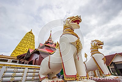 Golden Puttakaya chedipagoda with two giant Chinthe at the entrance,Sangkhlaburi district,Kanchanaburi,Thailand. Stock Photo